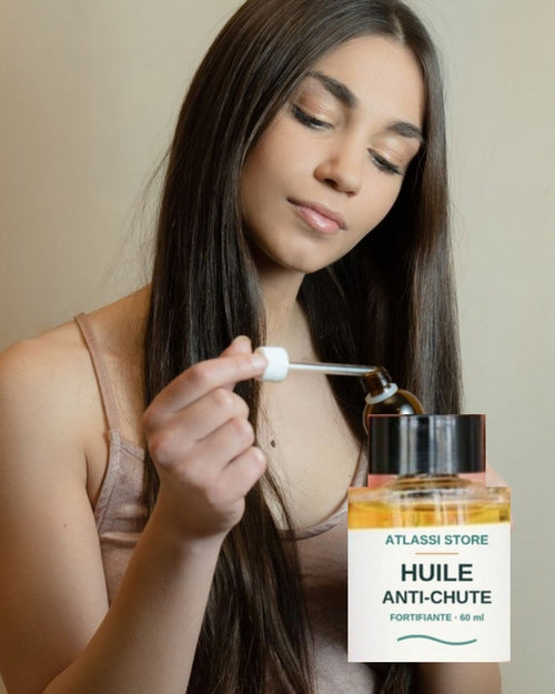 Femme appliquant l'Huile Anti-Chute Atlassi Store au compte-gouttes
